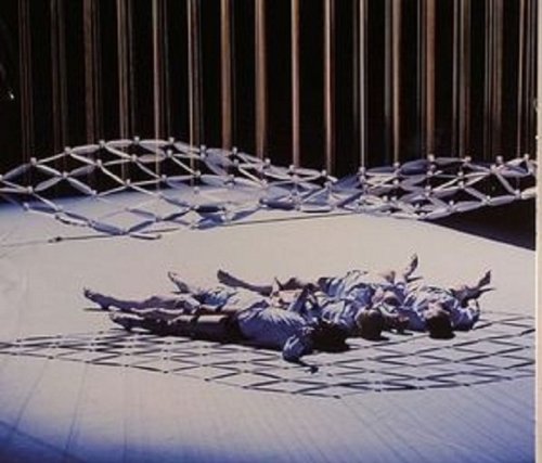 "Vinyl record cover featuring a person lying on a patterned floor with hanging ropes."