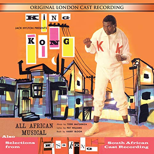"Album cover with a man in white, fists clenched, against an orange cityscape background."