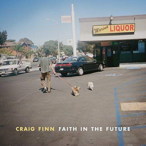 Album cover: man walking dogs in front of a liquor store.