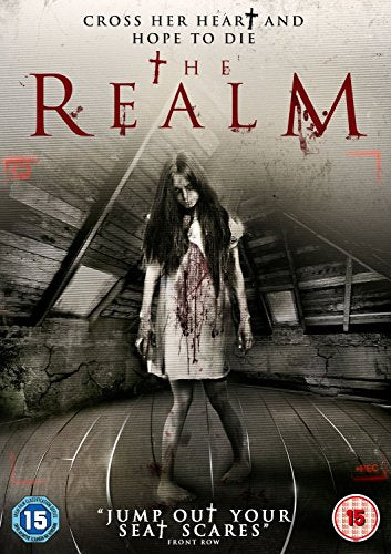 A girl in a blood-stained nightgown stands in a dark, wooden attic.