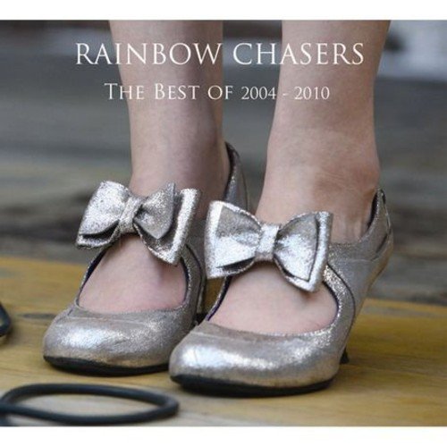 "Album cover featuring a pair of silver shoes with bows on a wooden floor."
