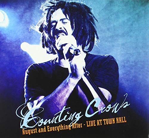 "CD cover featuring a man with dreadlocks singing into a microphone, blue background."