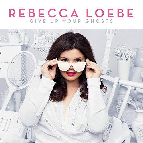 "Album cover featuring a woman in white, holding white sunglasses, with white background decor."