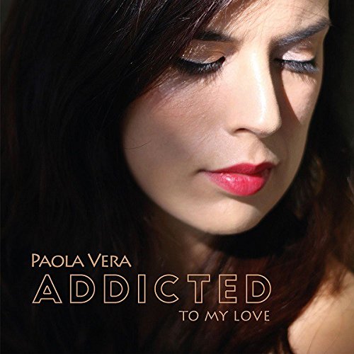 Woman with dark hair and closed eyes, album cover text "Paola Vera Addicted to My Love".