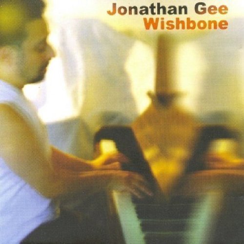 Album cover featuring a man playing piano, with artist name and album title.