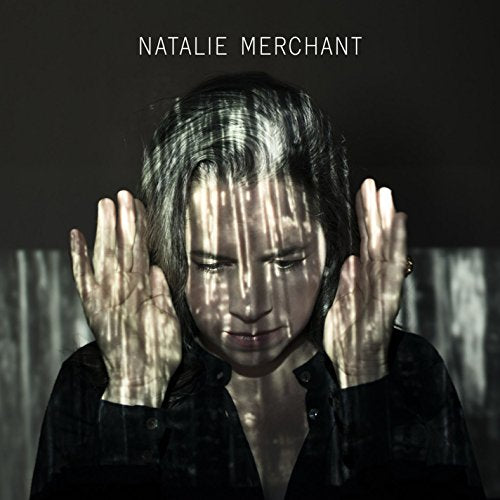 Natalie Merchant album cover featuring a woman with hands on her face, distorted reflection.