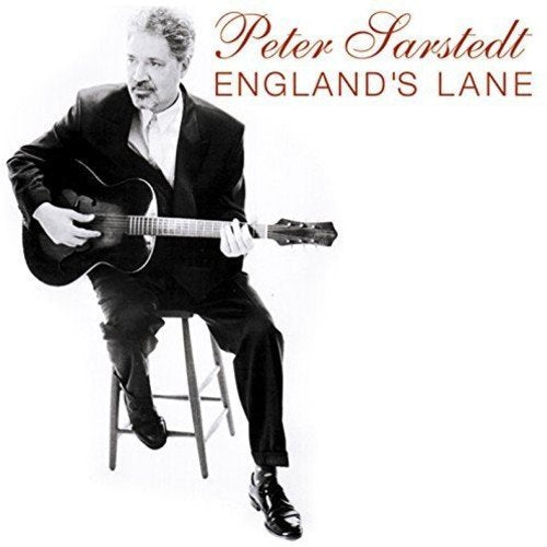 Peter Sarstedt sits with a guitar on a stool, album cover.