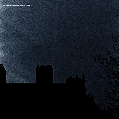 "Album cover with dark blue sky and silhouetted buildings, artist and title in white text."