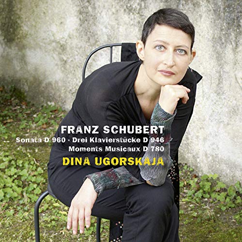 "CD cover with a woman sitting on a chair, wearing black, against a concrete wall."
