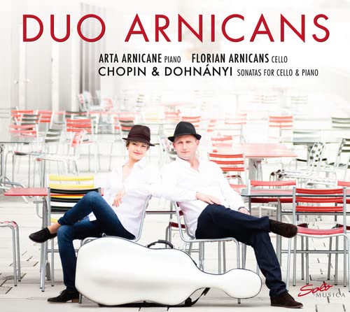 CD cover featuring two musicians with a cello case, outdoor setting.
