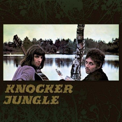 Vinyl album cover featuring a man standing by a tree near a lake.