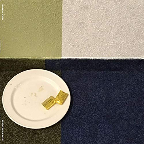 "White vinyl record cover with a plate and golden butter sticks on a colorful background."