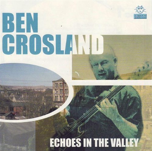 Album cover with a man playing cello and a town scene.