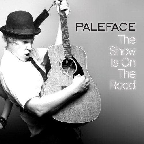 Black and white album cover with man holding guitar, wearing a bowler hat.