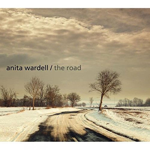"CD cover with snowy road and trees, artist name and album title."