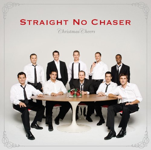 Nine men in suits and ties around a table with champagne.
