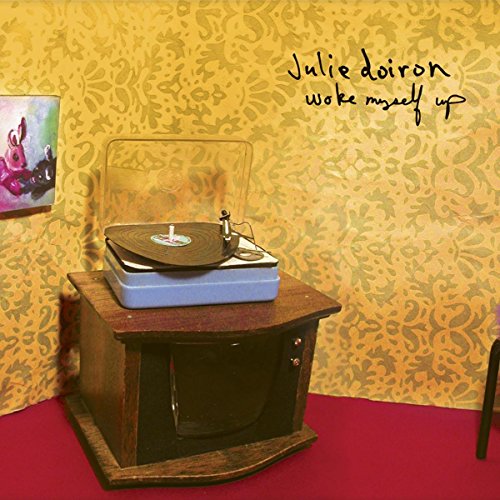 CD cover with a vintage record player on a wooden table.