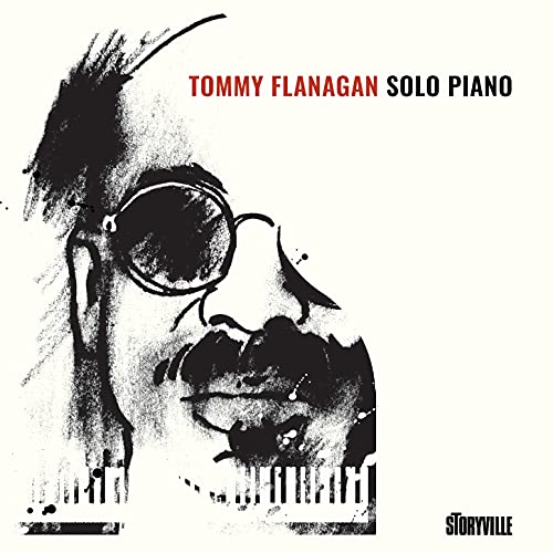 Black and white portrait of pianist Tommy Flanagan with piano keys.