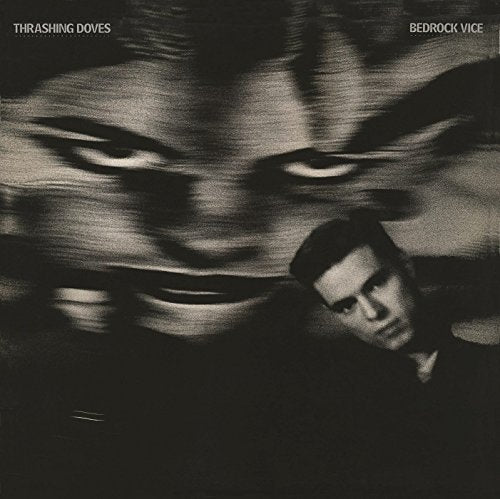 "Blurry black and white album cover with a man's face and figure."
