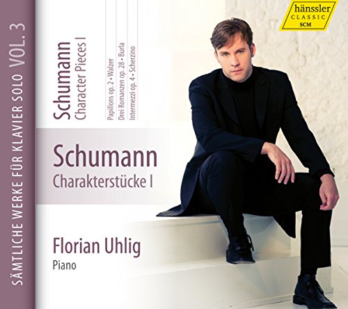 CD cover with a man sitting on white stairs, wearing black clothing and shoes.