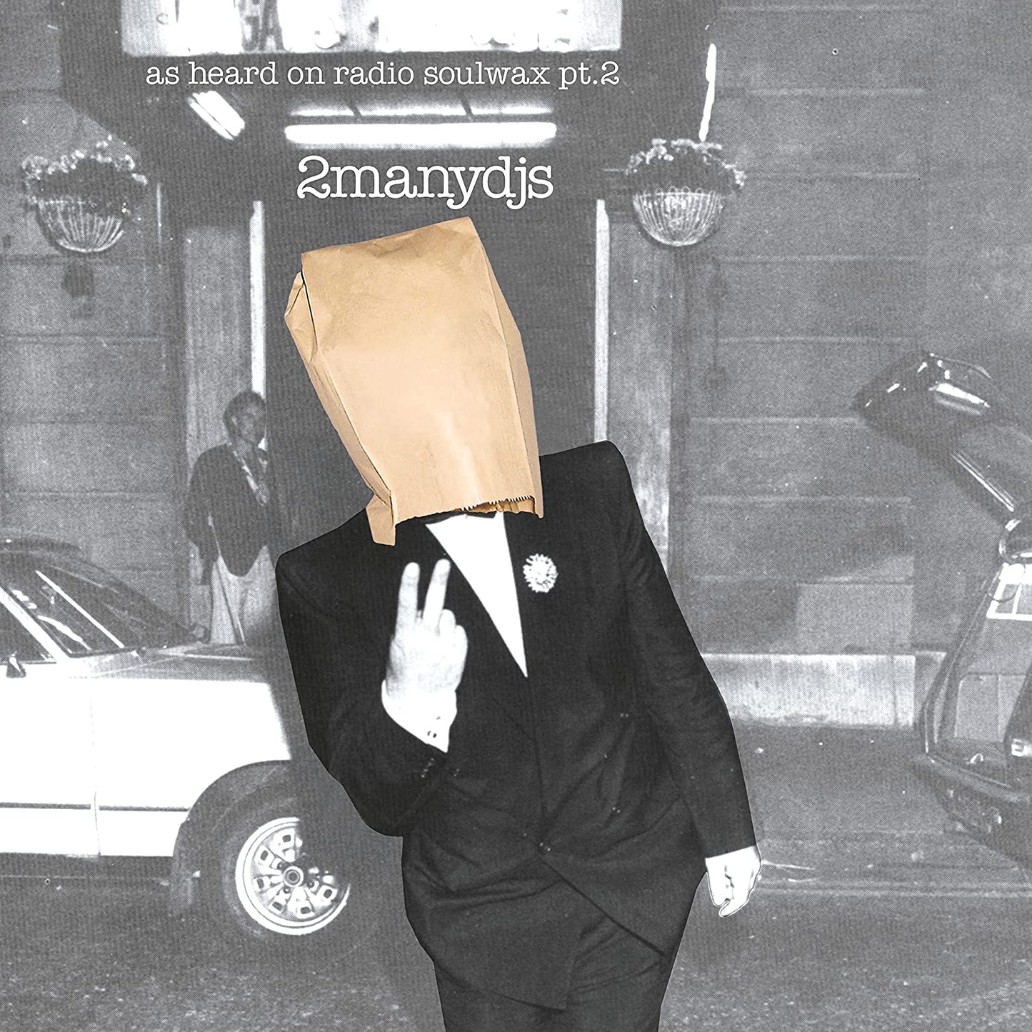 Black and white album cover with a man wearing a paper bag.