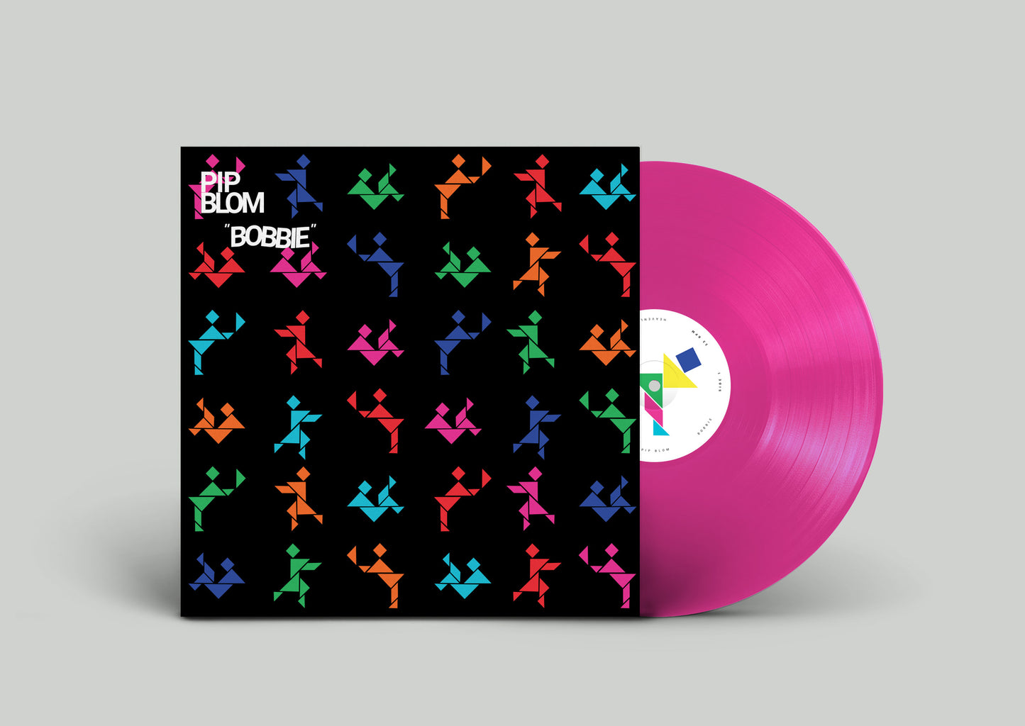 "Pink vinyl record with black sleeve featuring colorful origami cranes pattern and white text."