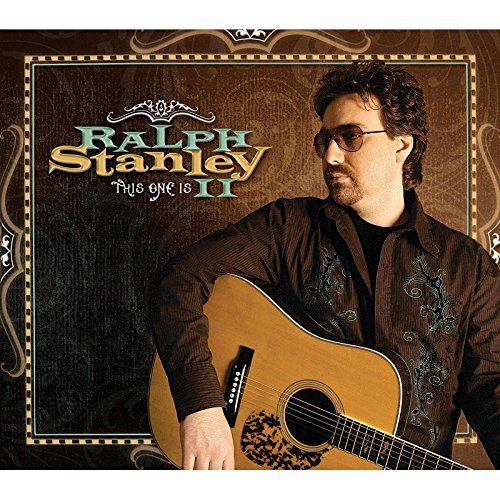 Man holding guitar, wearing sunglasses, on a brown album cover with ornate border.