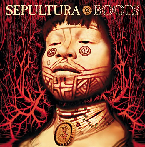 "Album cover with a face wearing a mask and tribal designs, surrounded by red branches."