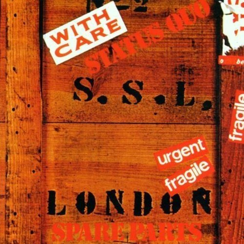 "Album cover featuring a distressed orange crate with 'Status Quo' and 'Spare Parts' labels."
