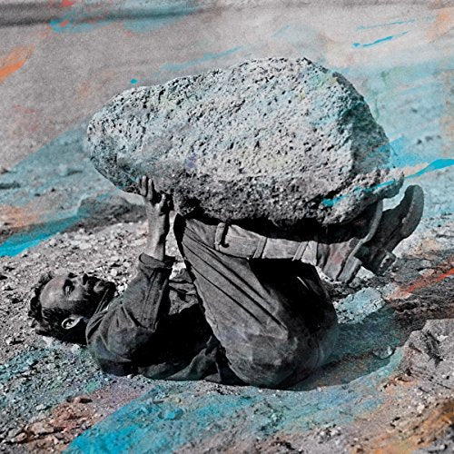 Man straining to lift a large rock, gritty and textured image.