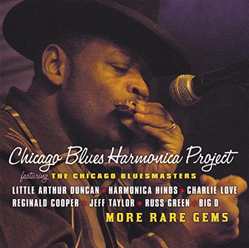 "Album cover featuring a man playing harmonica into a microphone, wearing a hat."