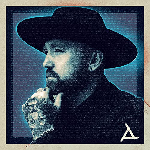 CD cover: Man in a hat with a statue held to his chest.