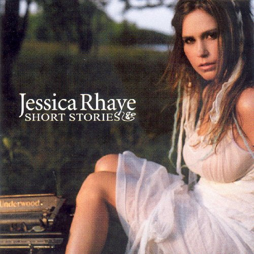 Album cover featuring a woman in a white dress sitting beside an old typewriter.