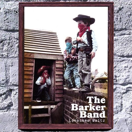 "CD cover with three masked cowboys and a wooden shack, on a stone background."