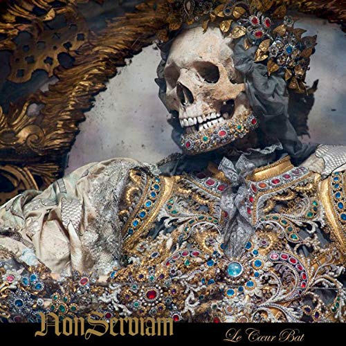"Album cover featuring a decorated skeleton wearing ornate, jewel-encrusted clothing and a crown."
