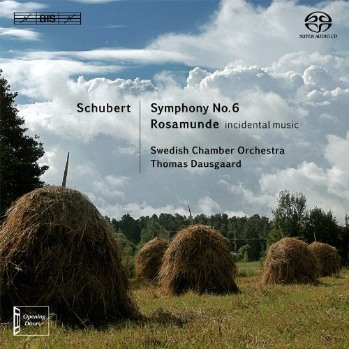 "CD cover featuring a serene field with haystacks under a cloudy sky."