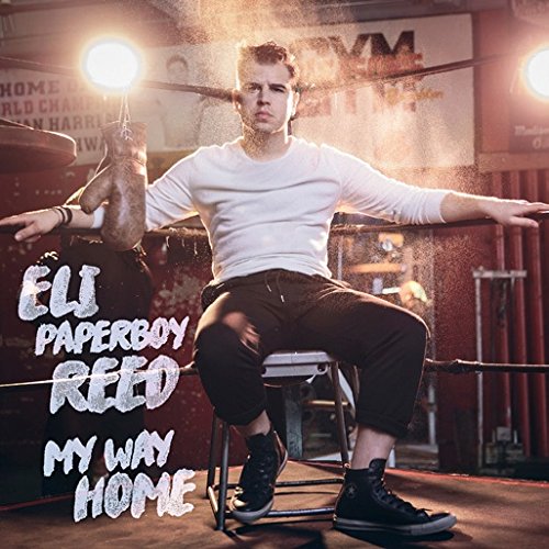 "Album cover: man sitting on stool in boxing ring with dust and spotlights."