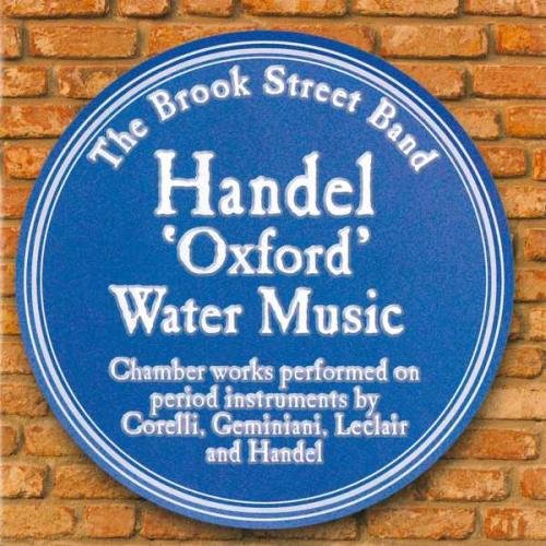 Blue circular album cover with white text on a brick background.