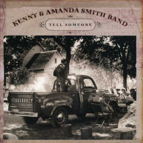 "Album cover with black and white photo of people gathered around an old truck."