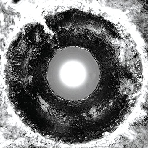 Black and white spiral pattern with a bright central light source.