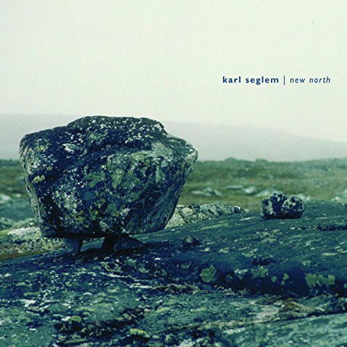 "CD cover featuring a large, mossy rock on a rocky, misty landscape."