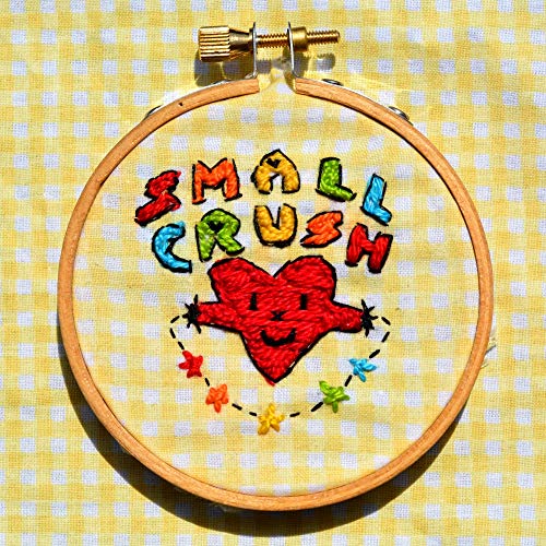 Embroidered "Small Crush" with a red heart in a wooden hoop.