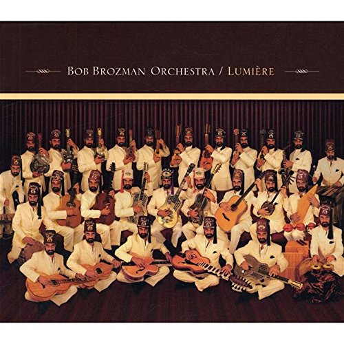 "Album cover featuring a large orchestra in white, holding various instruments, on a dark background."