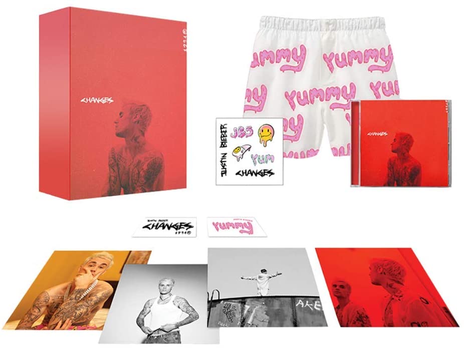 Red Justin Bieber box set with CD, shorts, and various inserts against a white background.