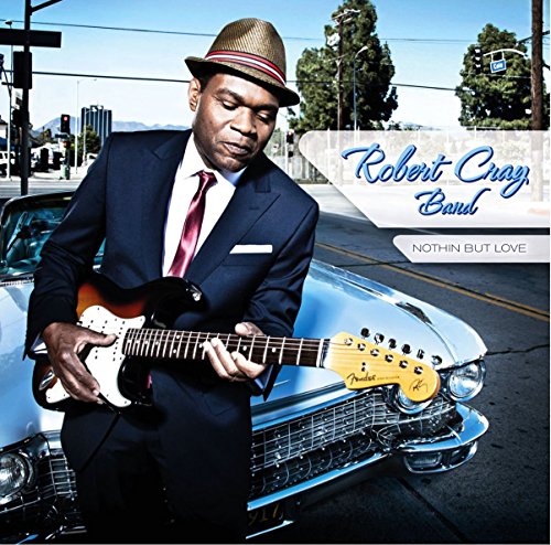 "Album cover featuring Robert Cray holding a guitar beside a classic car."