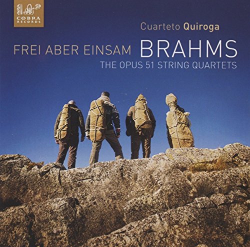 CD cover with four men standing on a rocky outcrop against a blue sky.