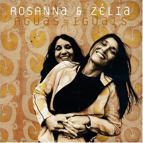 "CD cover featuring two smiling women embracing, with orange and yellow patterned background."