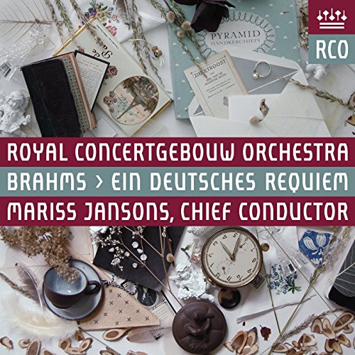 "CD cover with maroon banner, white text, and assorted decorative items on a white background."
