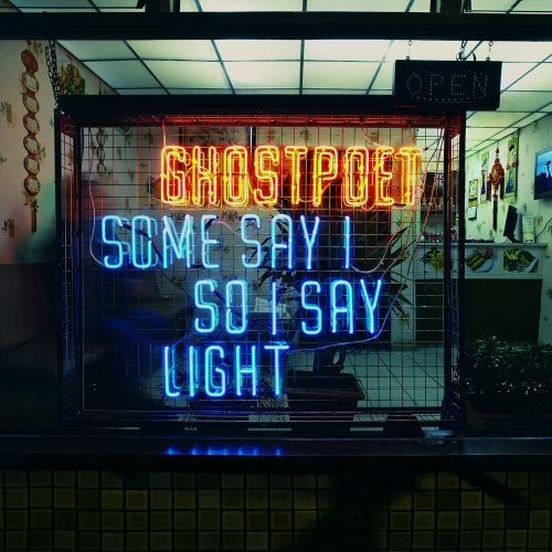 Neon sign reading "Ghostpoet Some Say I So I Say Light" in a shop window.
