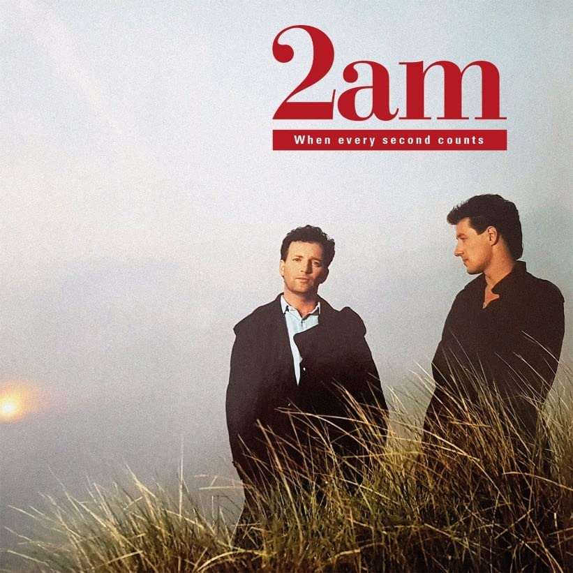 CD cover for “2am” featuring two men in dark suits, grassy foreground.